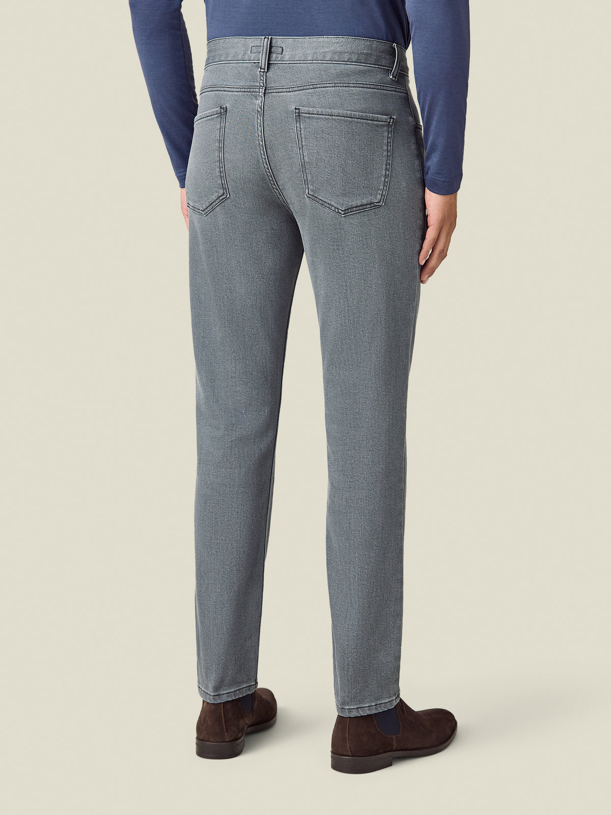 Back view of a model wearing the Luca Faloni Cashmere Denim Jeans in stone grey.