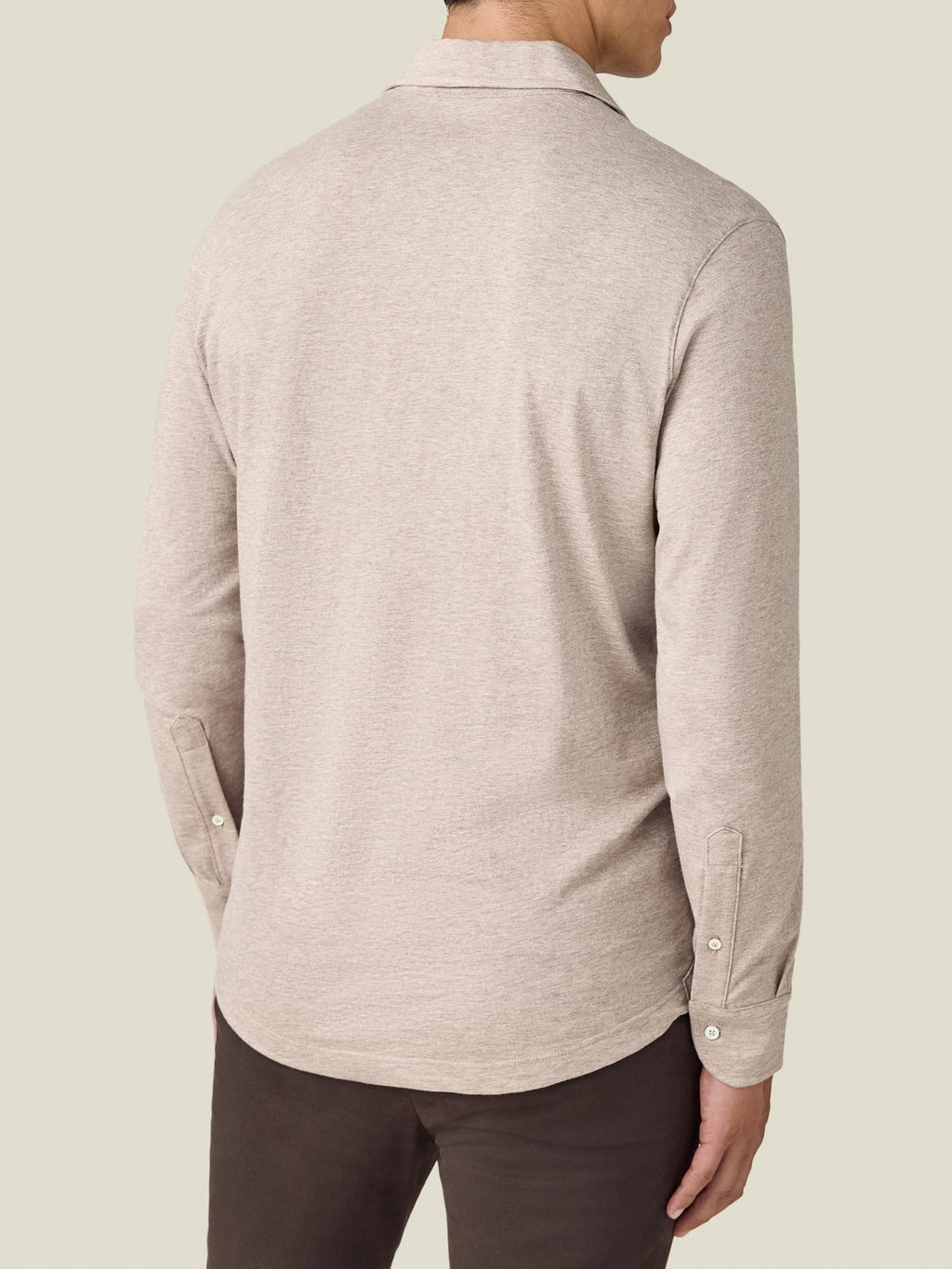 A rear view of a model wearing the Luca Faloni Cashmere-Cotton Long Sleeved Polo shirt in Oatmeal.