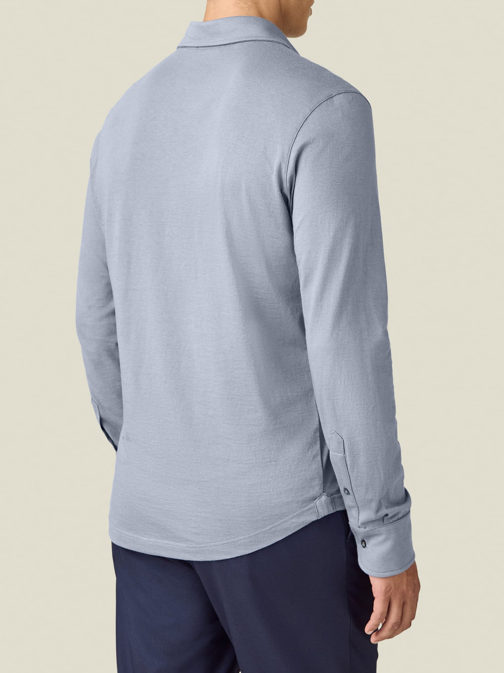 Rear view of a model wearing the Luca Faloni Cashmere-Cotton Long Sleeved Polo shirt in French Blue.