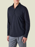 A man models the Cashmere-Cotton Long Sleeved Polo Shirt in Midnight Blue, shown from a three-quarter front view.