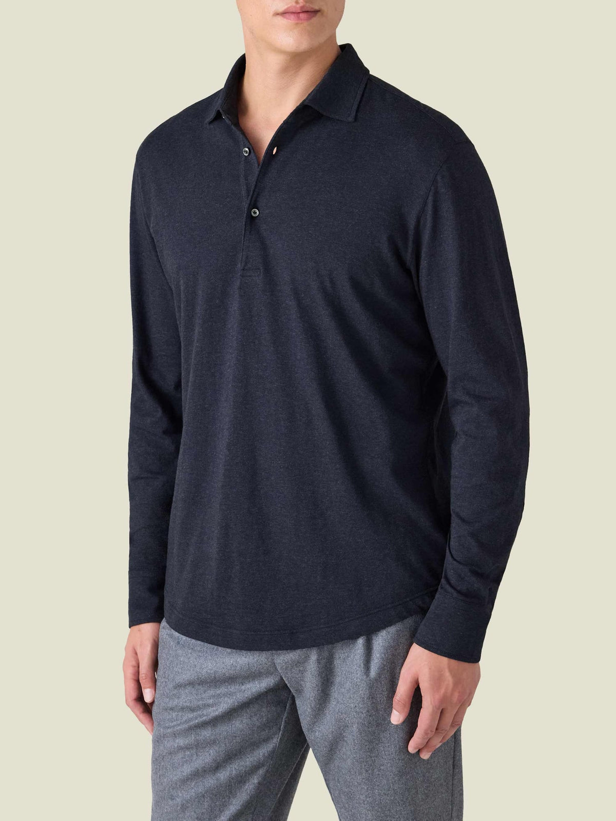 A man models the Cashmere-Cotton Long Sleeved Polo Shirt in Midnight Blue, shown from a three-quarter front view.