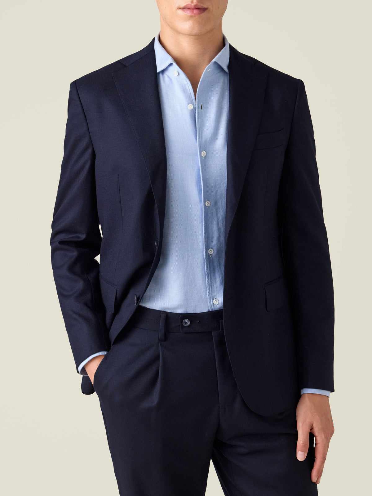 Close-up of a model wearing the Midnight Blue Wool Suit, highlighting the single-breasted jacket and pleated trousers.
