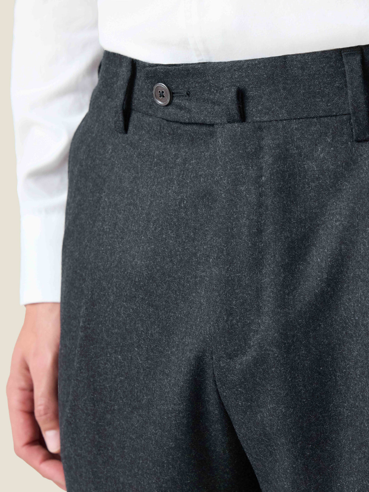Close-up of the Charcoal Grey Wool Suit trousers, showing the brushed wool fabric, single pleat, and waistband.
