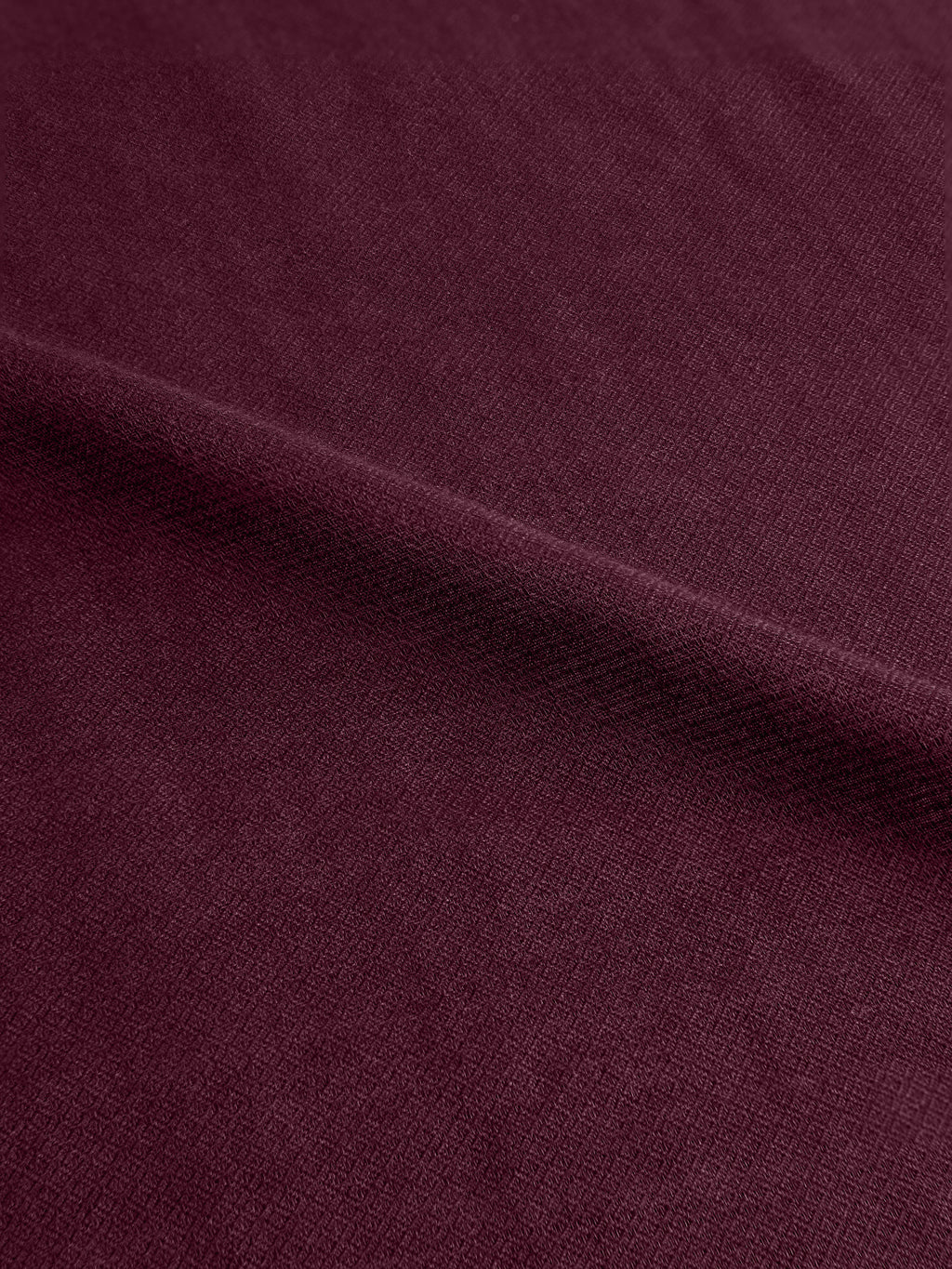 A close-up of the Luca Faloni Silk-Cashmere Scarf in Burgundy, showing its soft handle and distinctive micro-diamond texture.