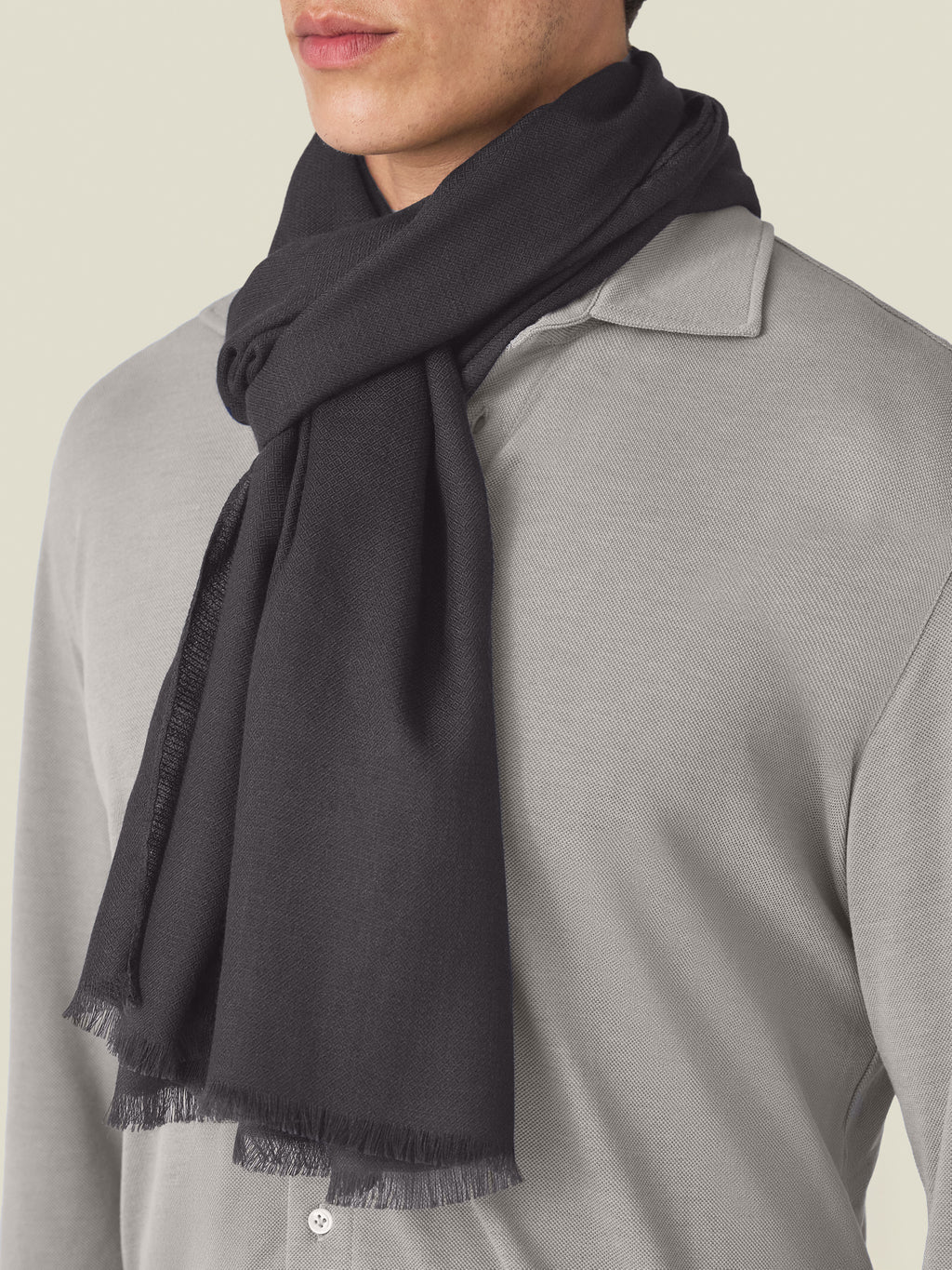 Close-up of a model wearing the Luca Faloni Silk-Cashmere Scarf in charcoal grey.