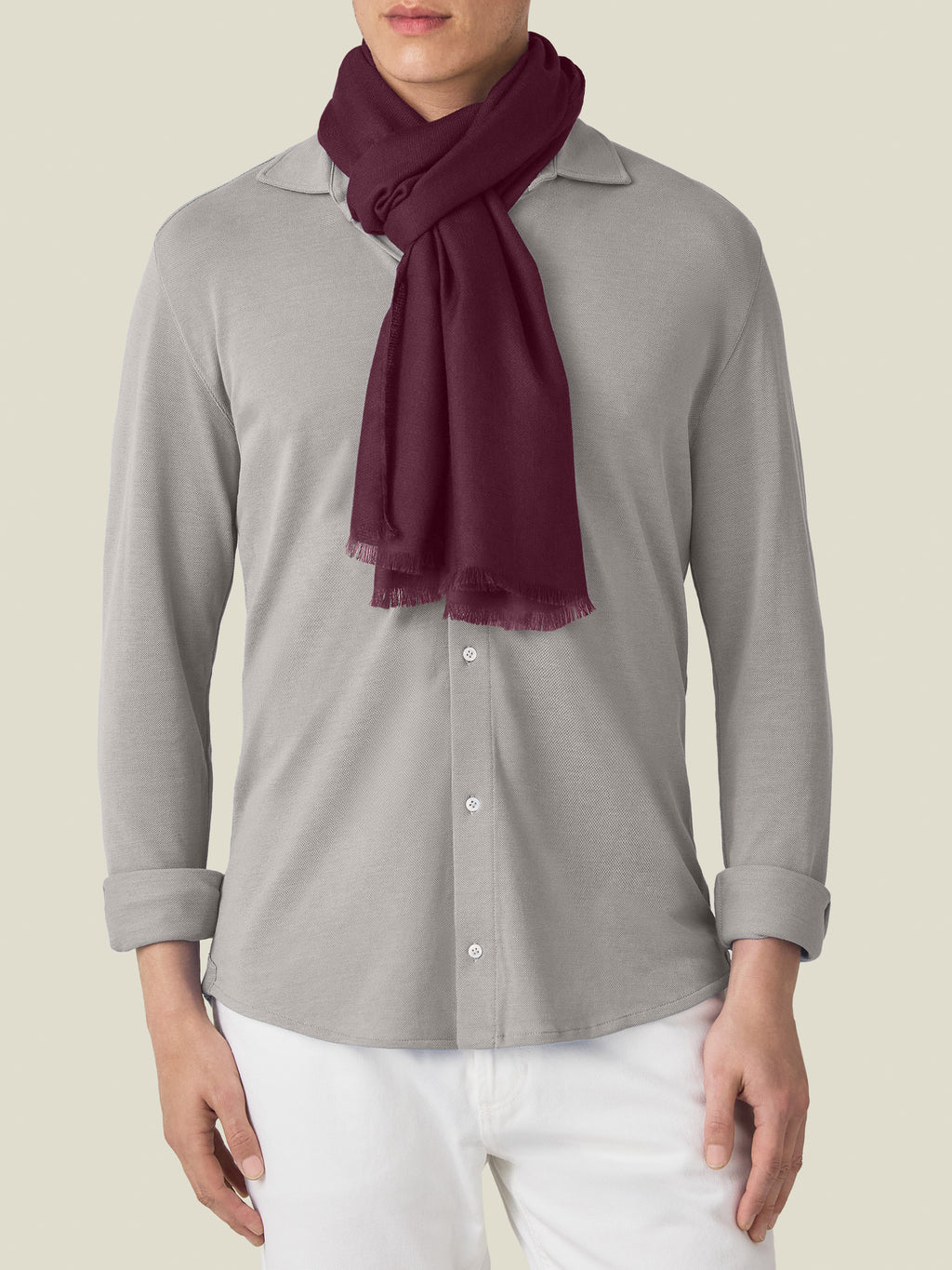 A model wears the Luca Faloni Silk-Cashmere Scarf in Burgundy, styled over a light grey long-sleeve shirt.