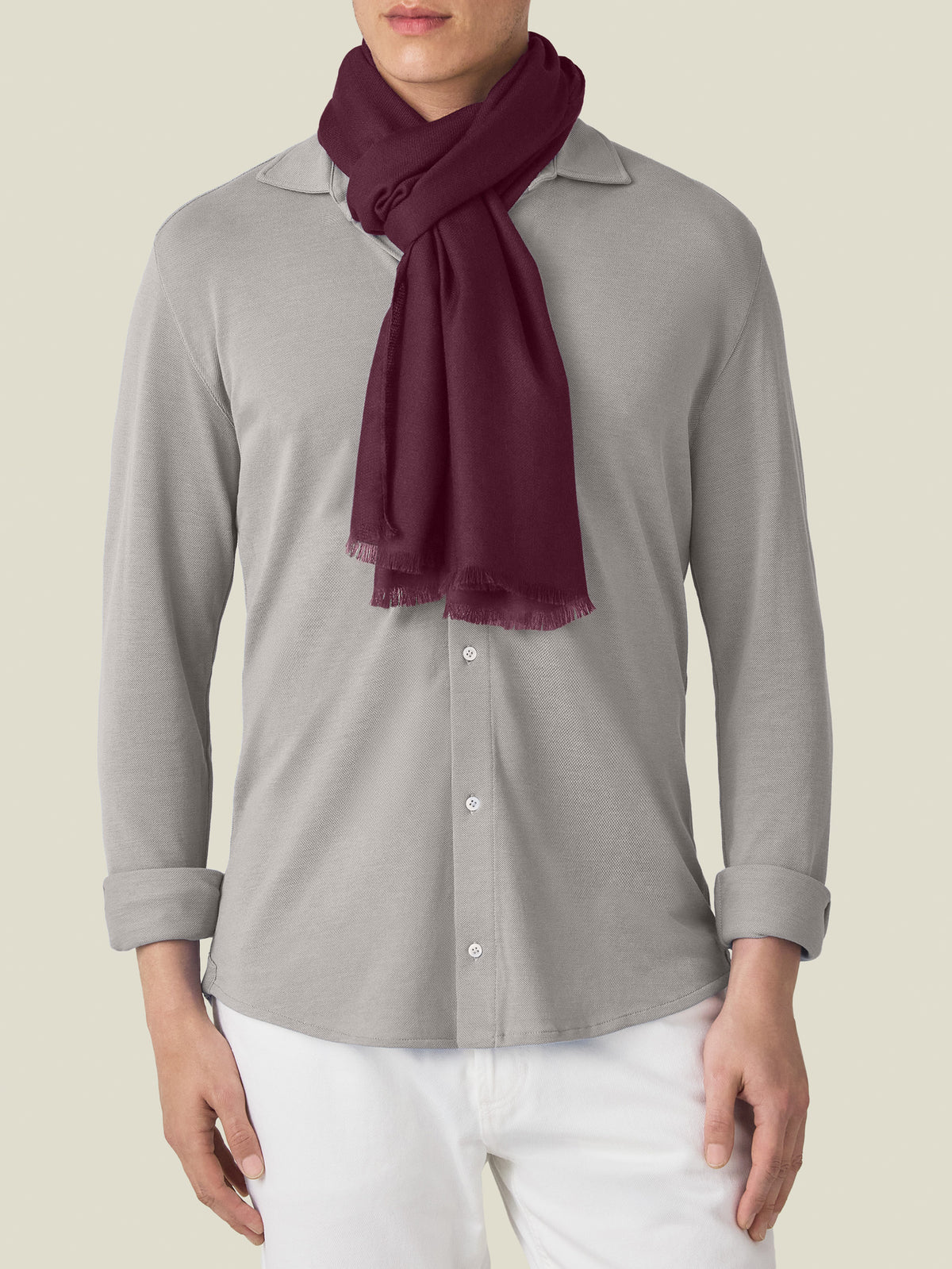A model wears the Luca Faloni Silk-Cashmere Scarf in Burgundy, styled over a light grey long-sleeve shirt.