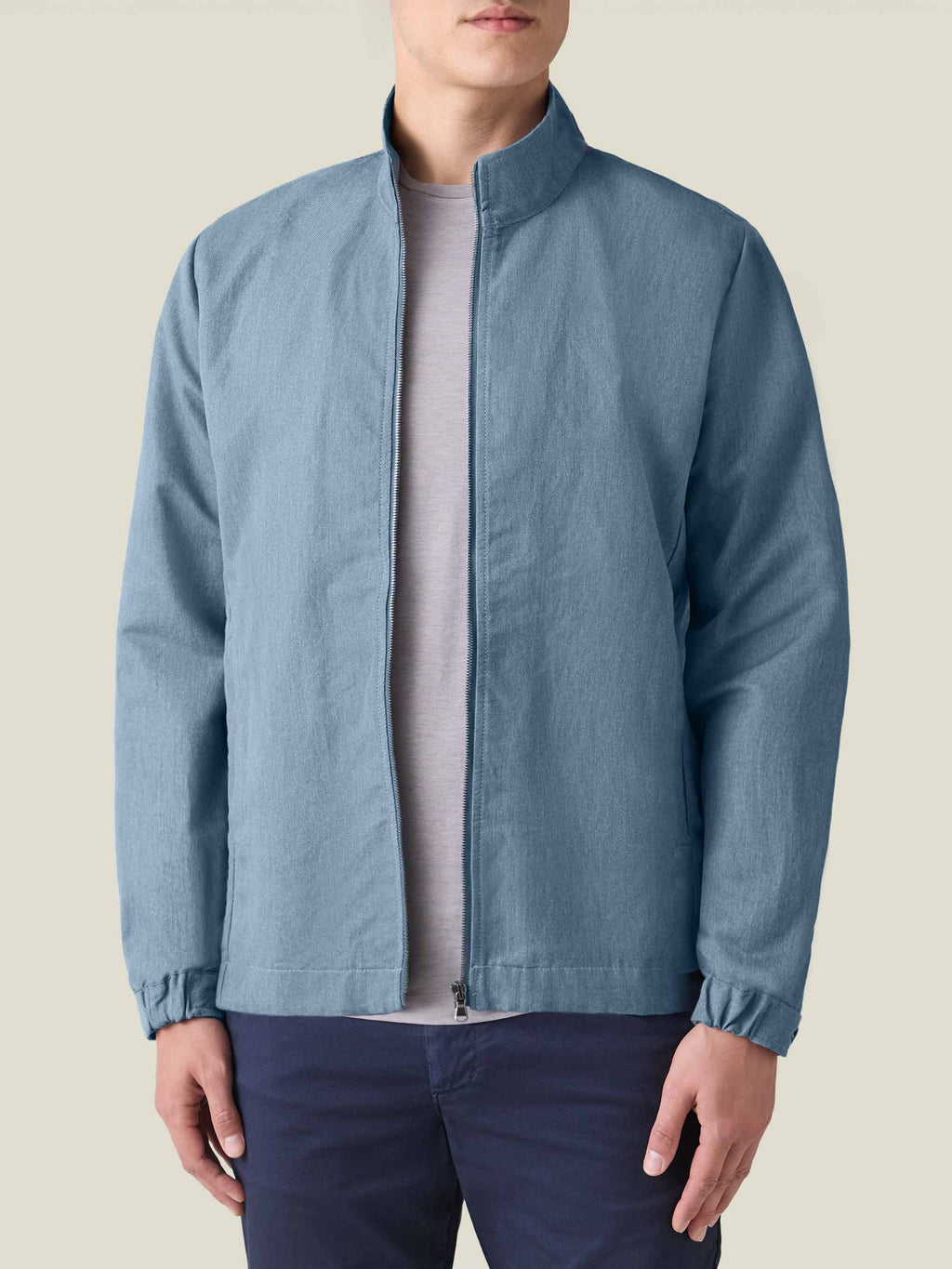 Front view of a model wearing the Luca Faloni Linen Bomber Jacket in French blue against a plain background.