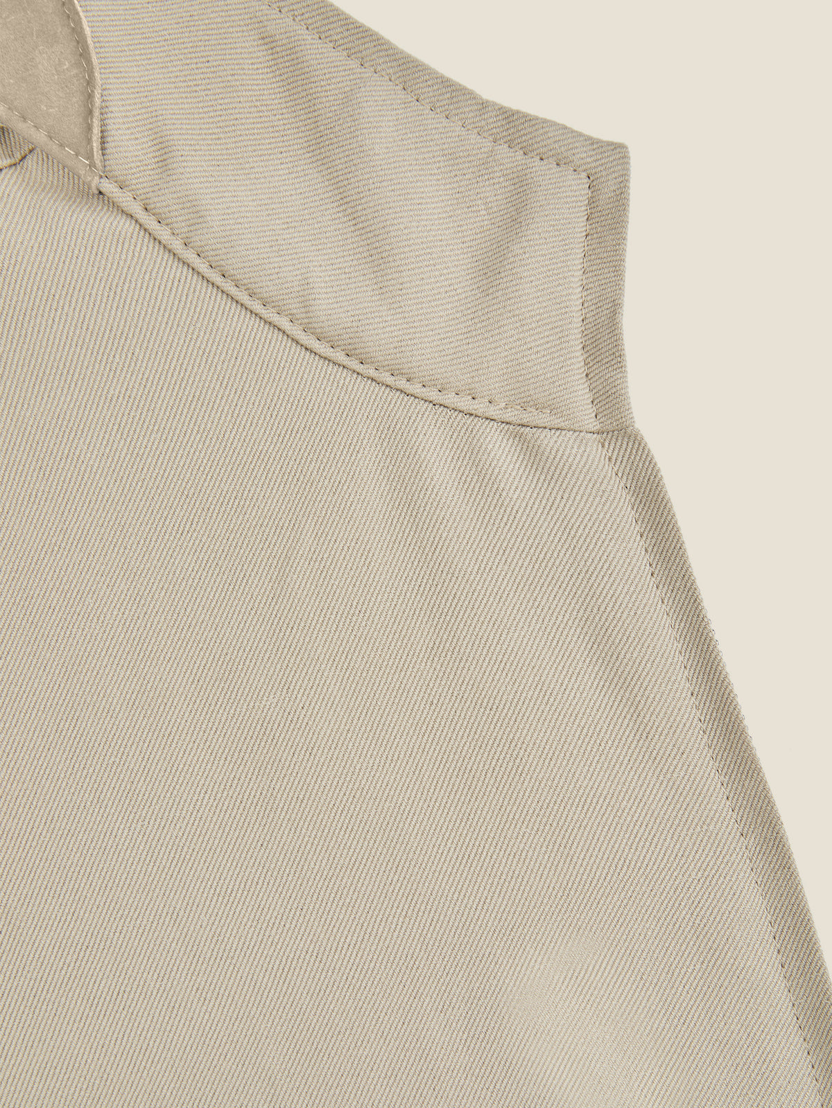 Close-up detail of the collar of the Luca Faloni Linen Bomber Jacket in sand, showing the fabric and stitching.