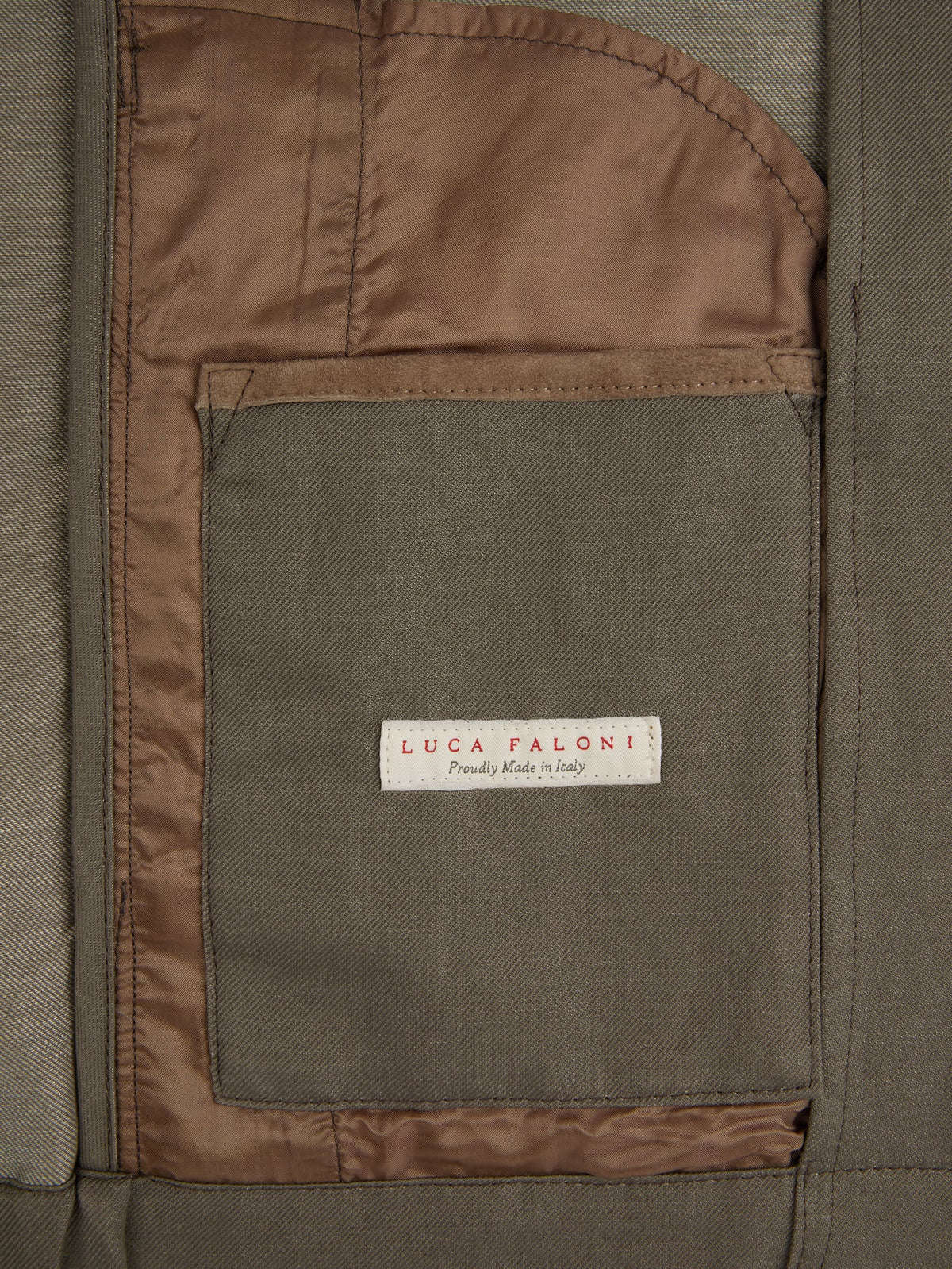 Close-up of the Nocciola Brown Linen Bomber Jacket's internal pocket, showing the 'Proudly Made in Italy' label.