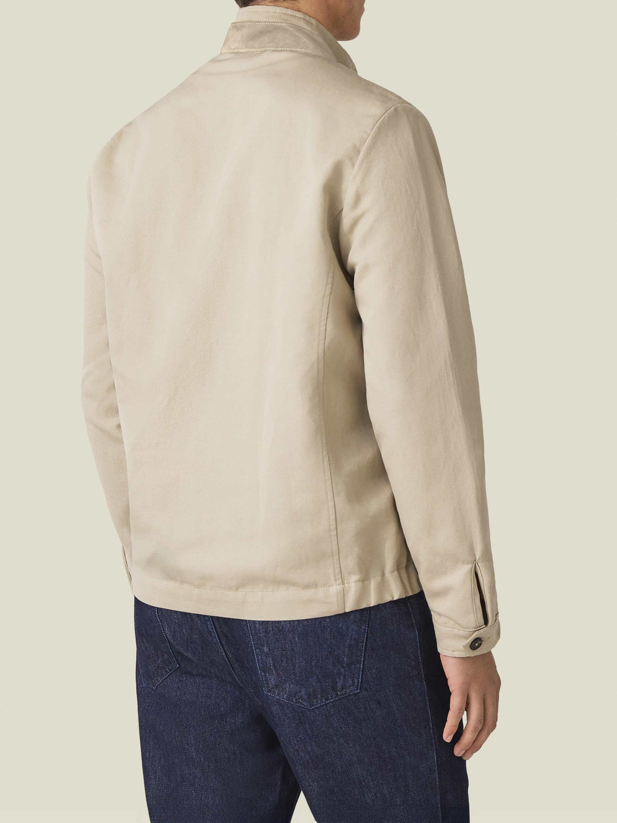 Back view of the Luca Faloni Linen Bomber Jacket in sand, worn by a model against a plain background.