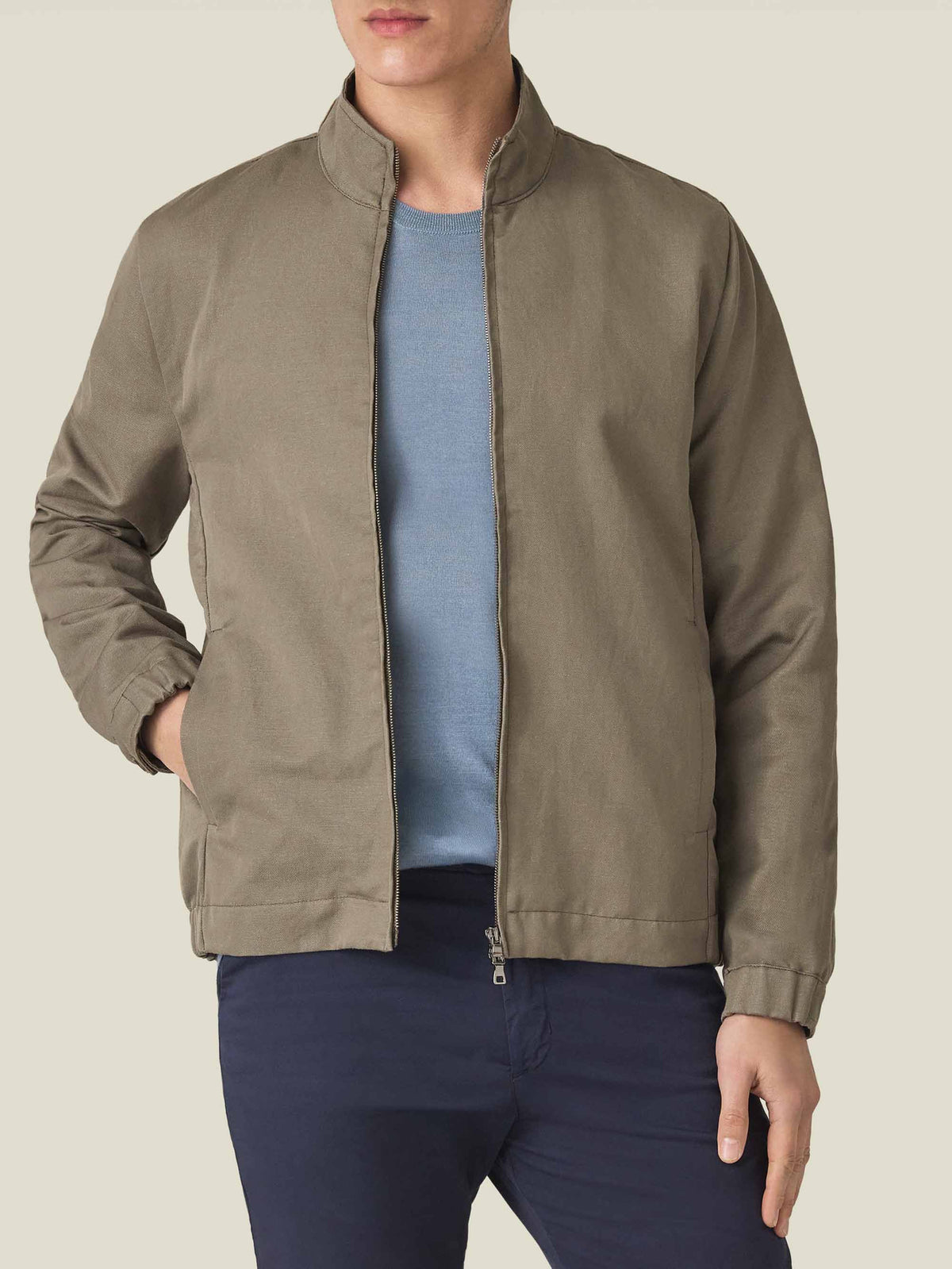 Front view of a model wearing the Luca Faloni Linen Bomber Jacket in nocciola brown.