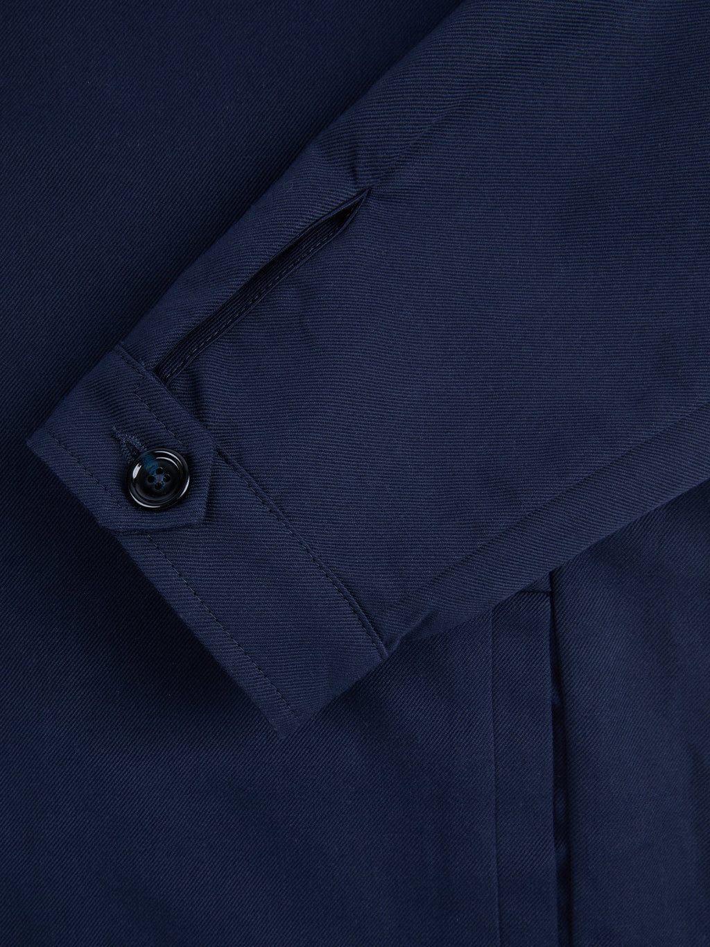 Close-up of the single horn button cuff on the Midnight Blue Linen Bomber Jacket.