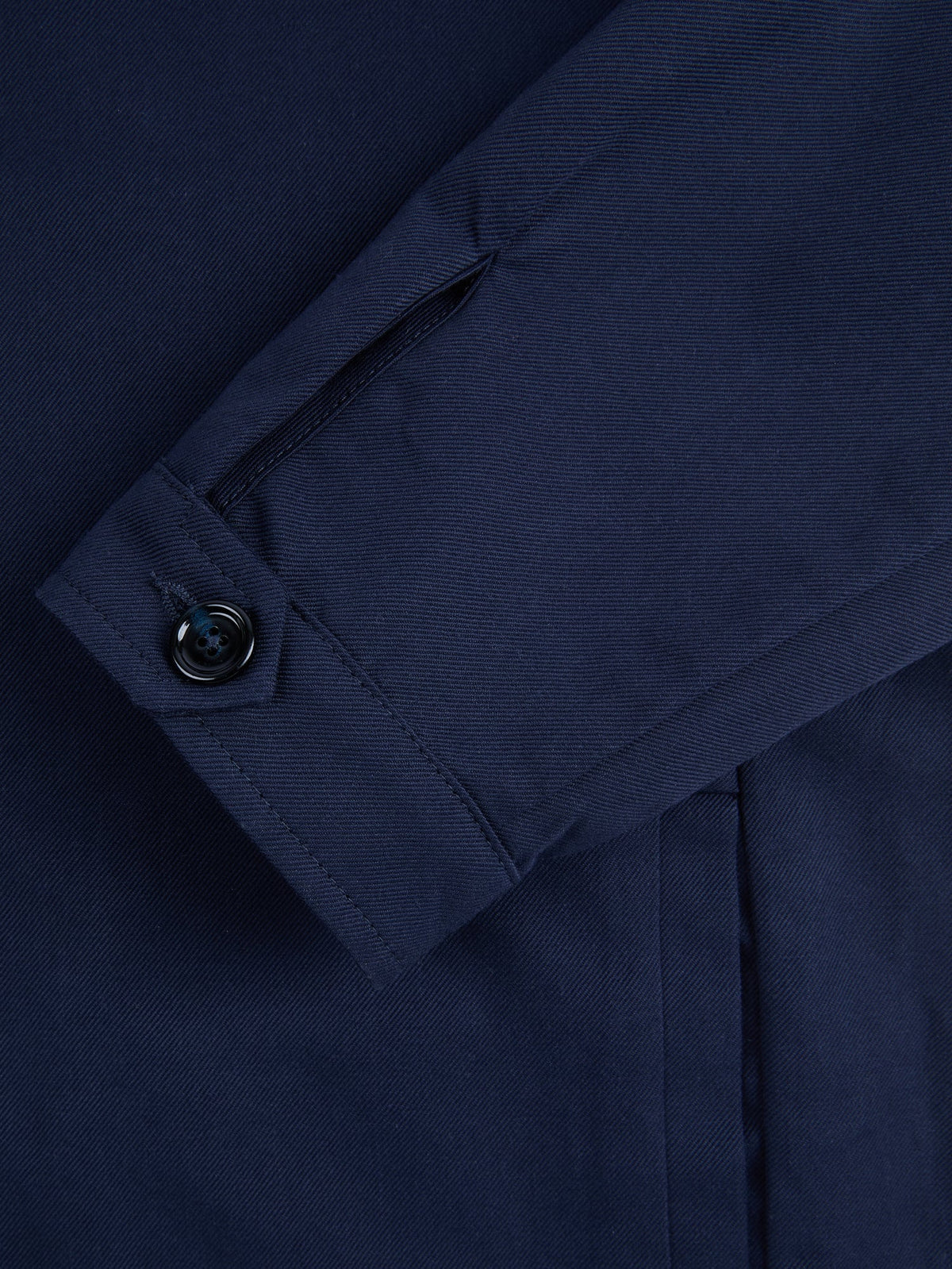 Close-up of the single horn button cuff on the Midnight Blue Linen Bomber Jacket.