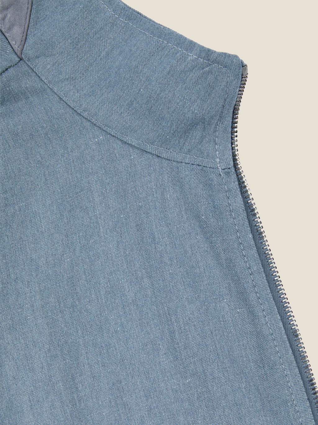 A detailed close-up of the shoulder, zip, and suede collar of the Luca Faloni Linen Bomber Jacket in French Blue.