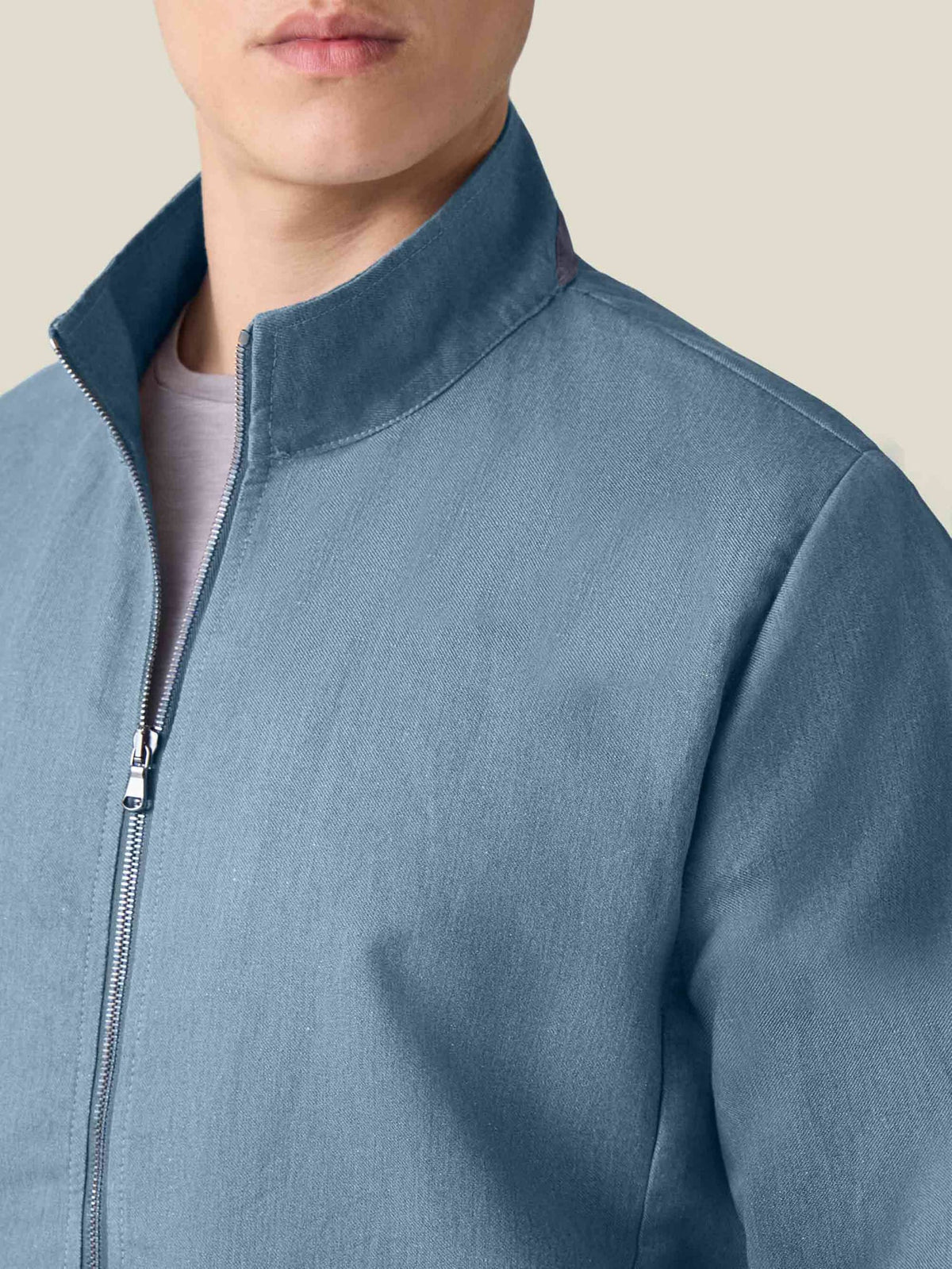 Close-up of the collar detail on the Luca Faloni Linen Bomber Jacket in French blue.