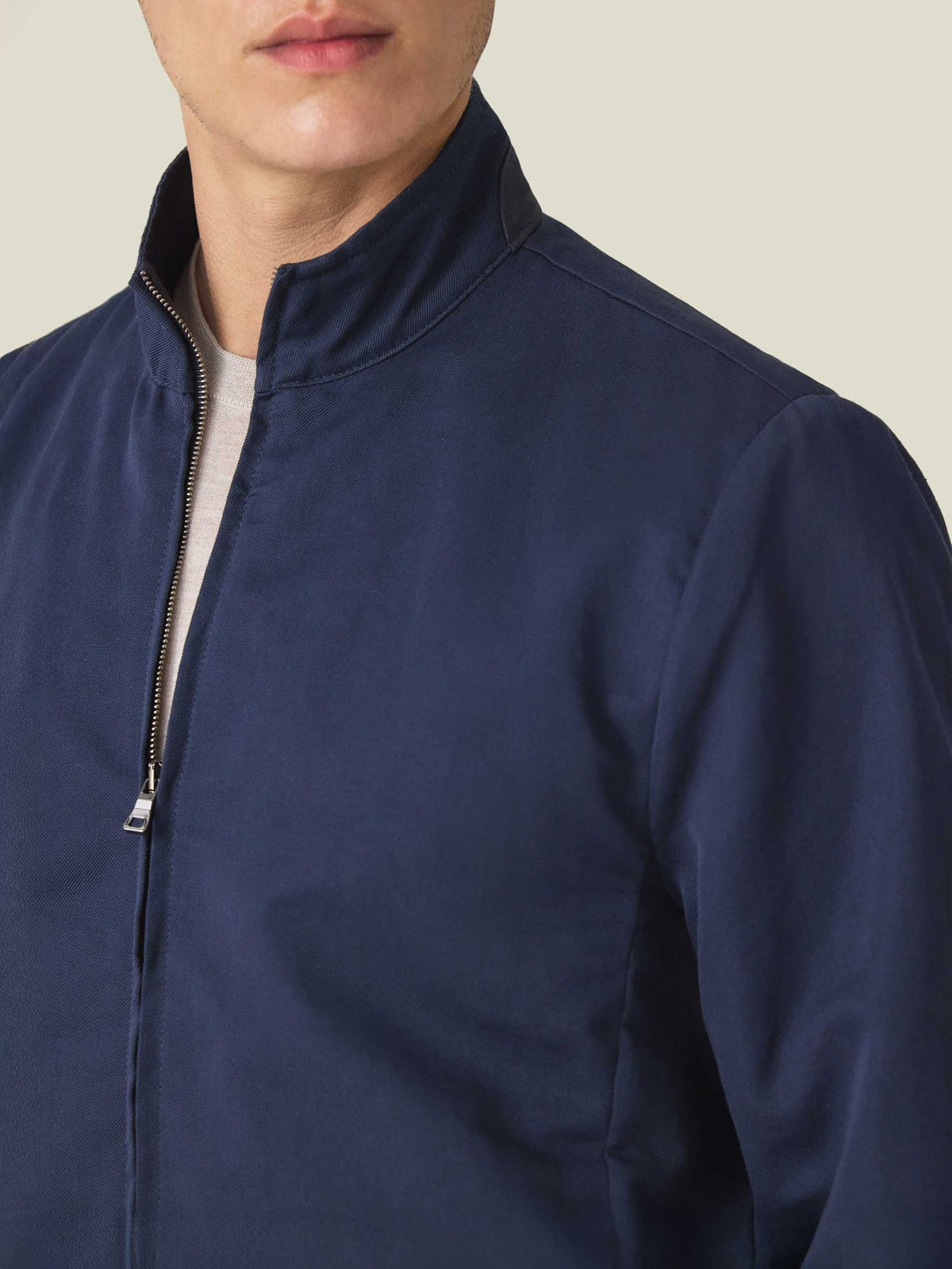 Close-up of a model wearing the Midnight Blue Linen Bomber Jacket, showcasing the high collar and front zip detail.