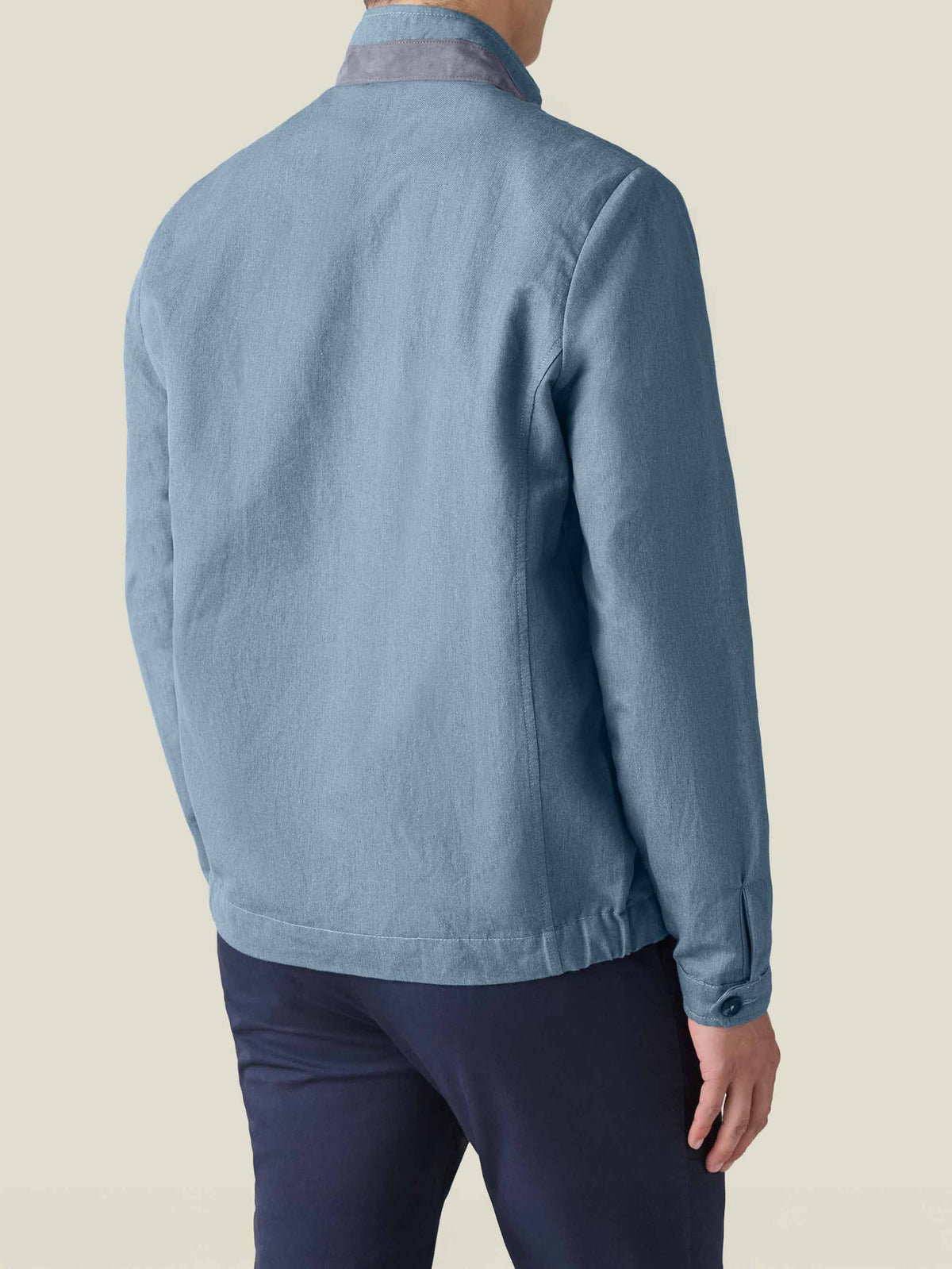 Back view of a model wearing the Luca Faloni Linen Bomber Jacket in French Blue.