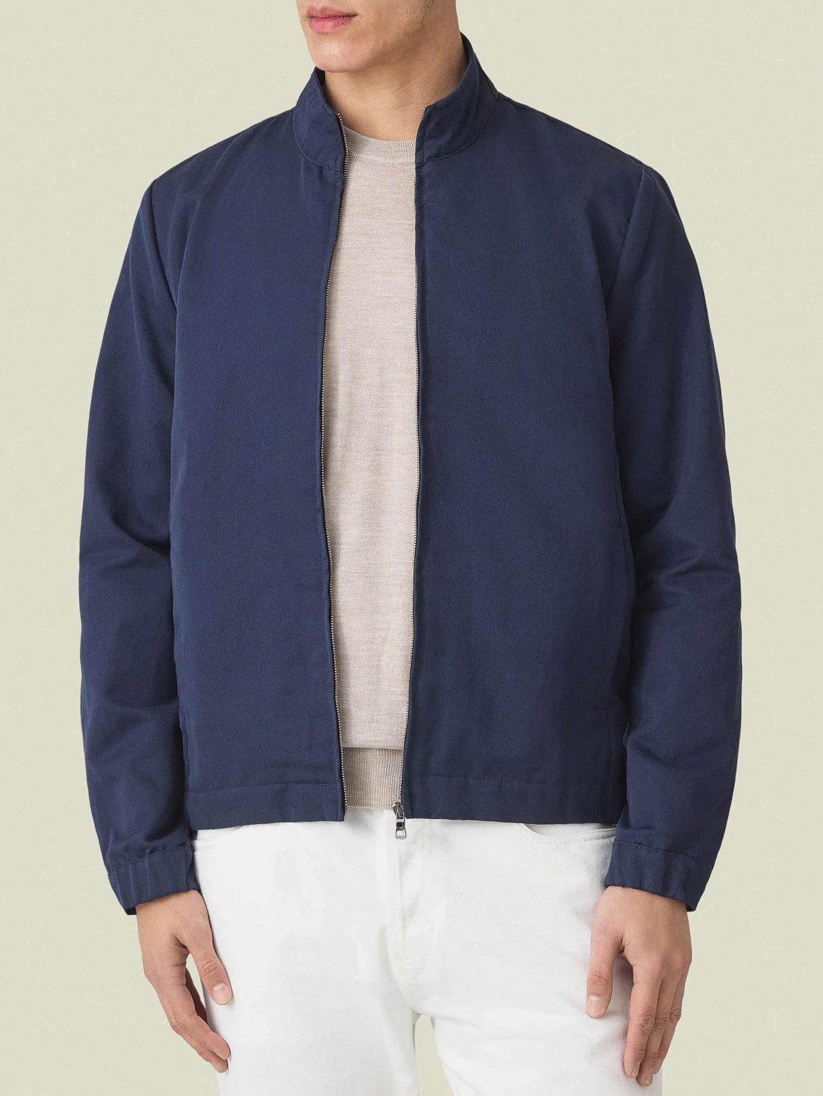 Front view of a model wearing the Luca Faloni Linen Bomber Jacket in Midnight Blue, styled open over a light-coloured knit.