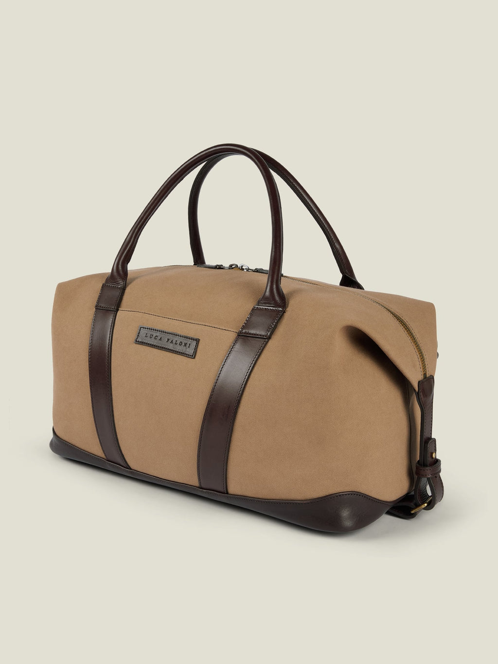 Studio shot of the Luca Faloni Canvas Weekender in Caramel Brown, showing its dark leather handles, trim, and base.