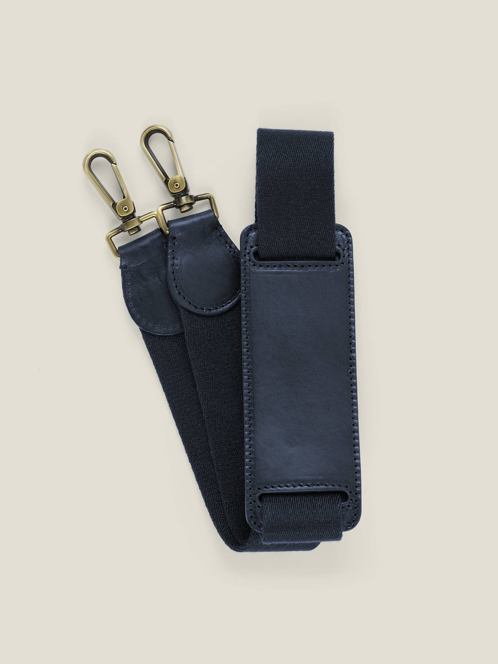 Close-up of the detachable shoulder strap for the Midnight Blue Canvas Bag, showing the leather pad and brass hardware.