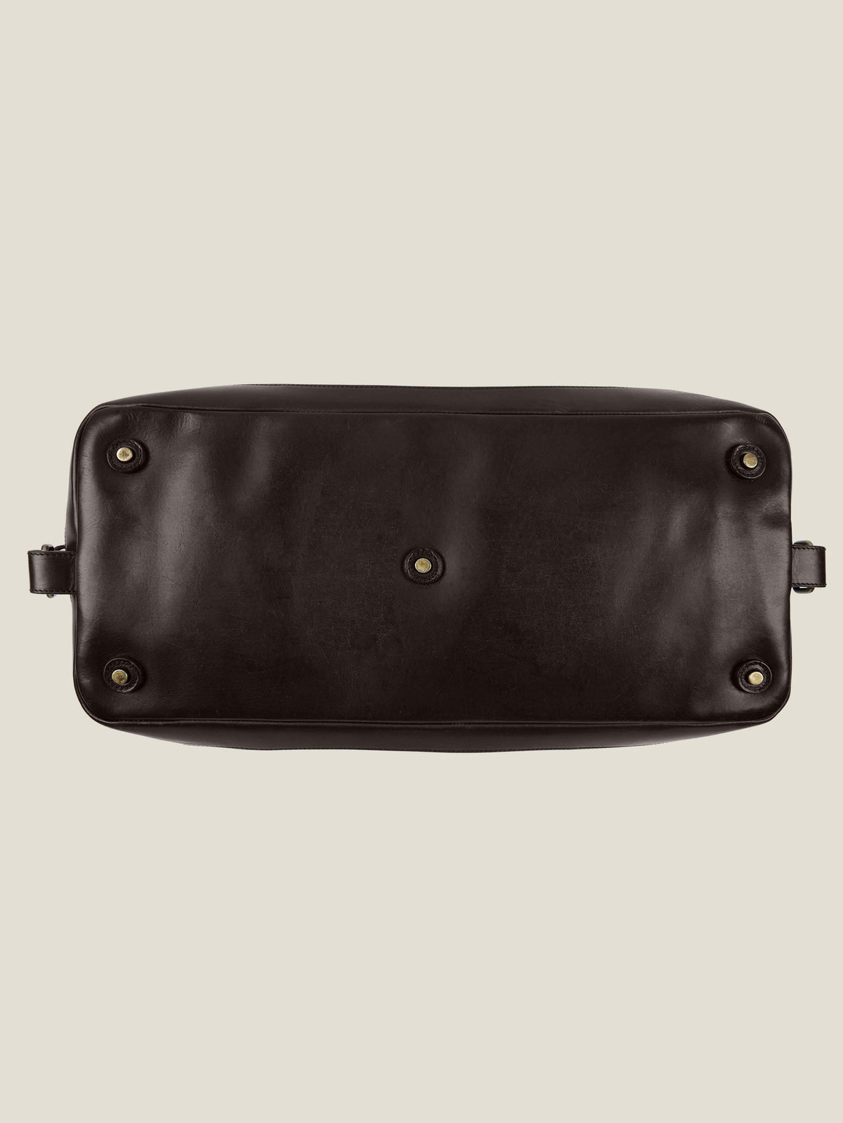 Bottom view of the French Blue Canvas Bag, showing the dark brown leather base with protective metal studs.