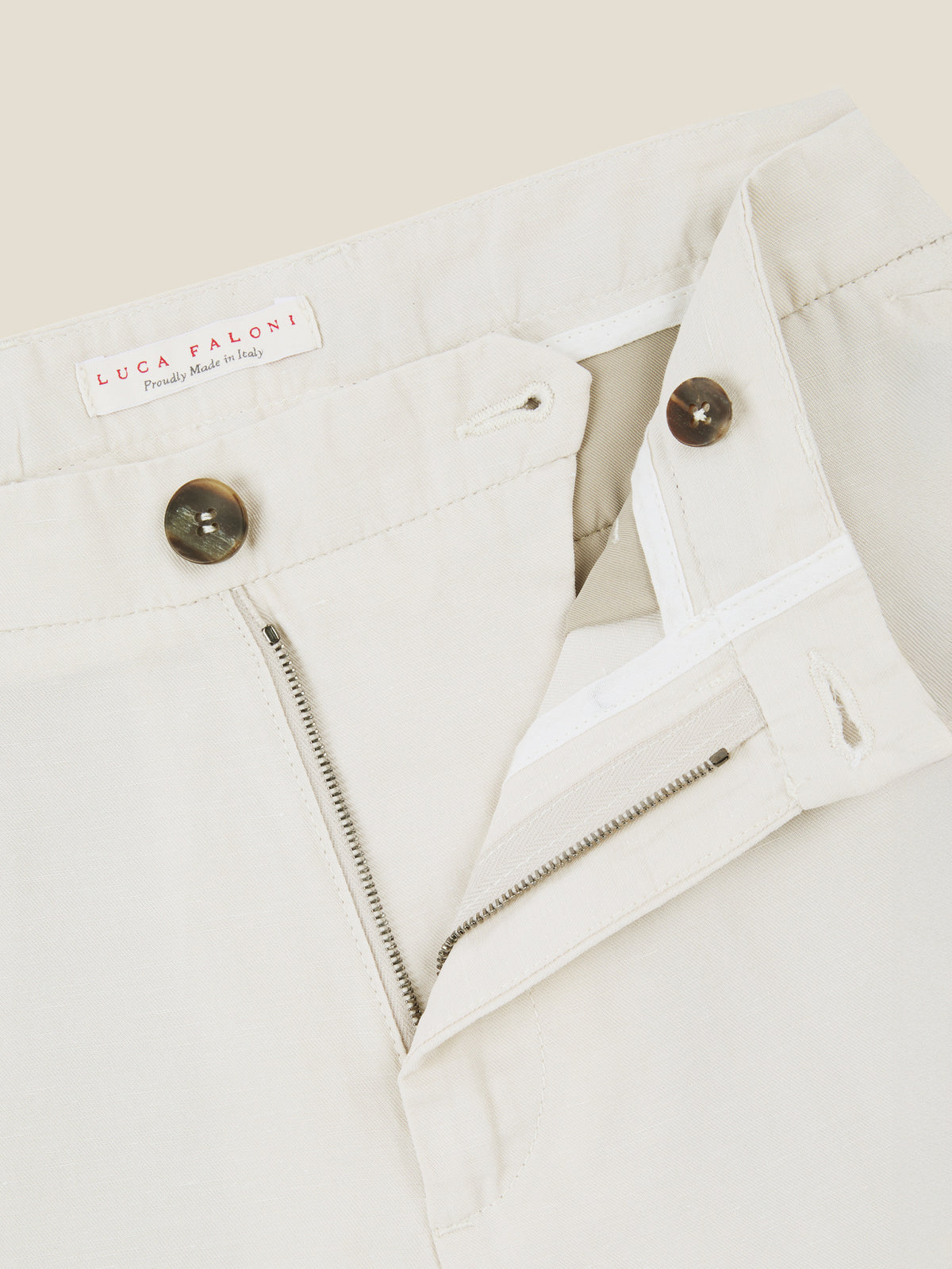 Close-up on the horn button closure, Lanfranchi zip, and waistband of Luca Faloni's Sand Linen Cotton Trousers.