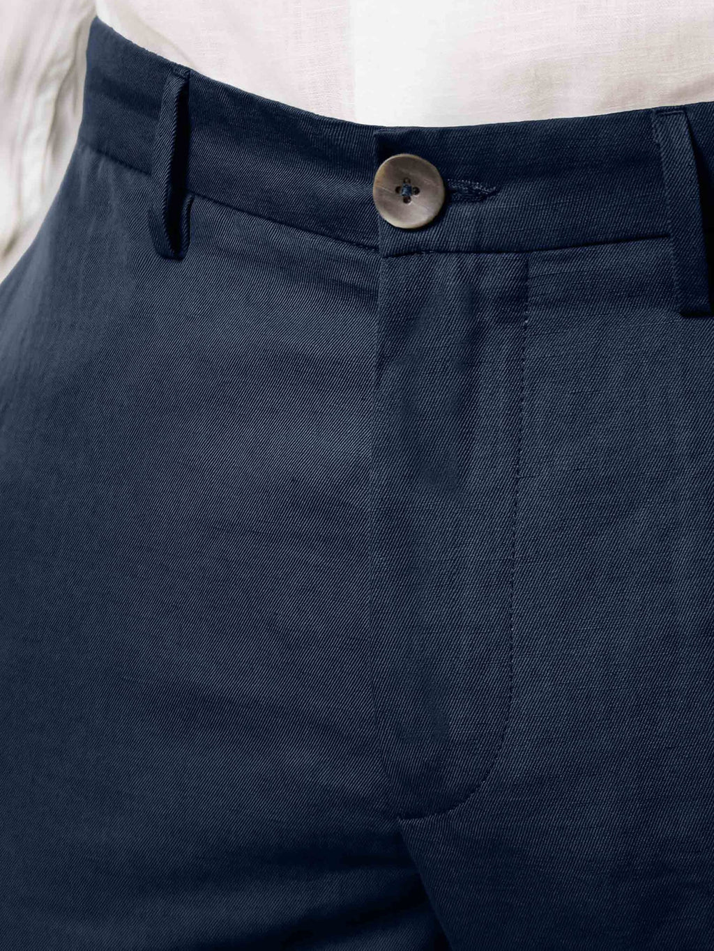 A close-up of the Midnight Blue Linen Cotton Trousers, showing the fabric texture and horn button detail.