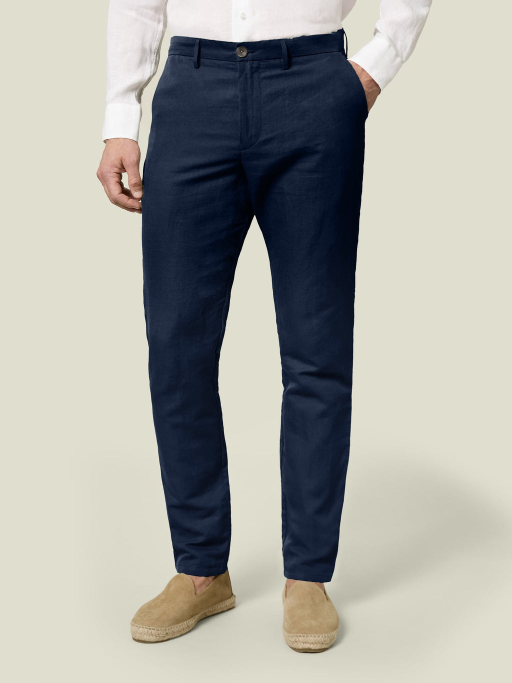 Front view of a man wearing Luca Faloni's Midnight Blue Linen Cotton Trousers with a white shirt and tan espadrilles.