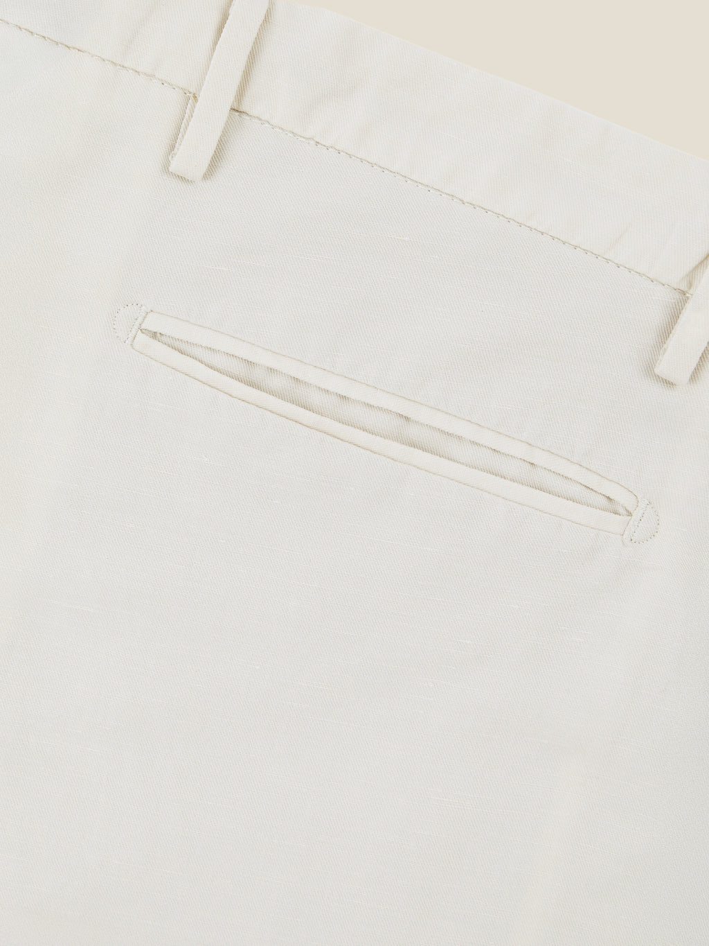 Close-up of the welt back pocket on the Sand Linen Cotton Trousers, showcasing the fine Italian craftsmanship.