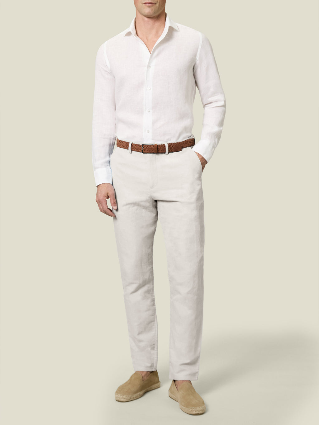 Front view of a model in Sand Linen Cotton Trousers, styled with a white shirt, brown belt and espadrilles.