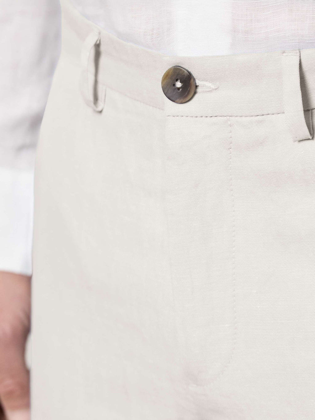 Waistband detail of the Sand Linen Cotton Trousers, featuring the fabric texture and dark horn button closure.
