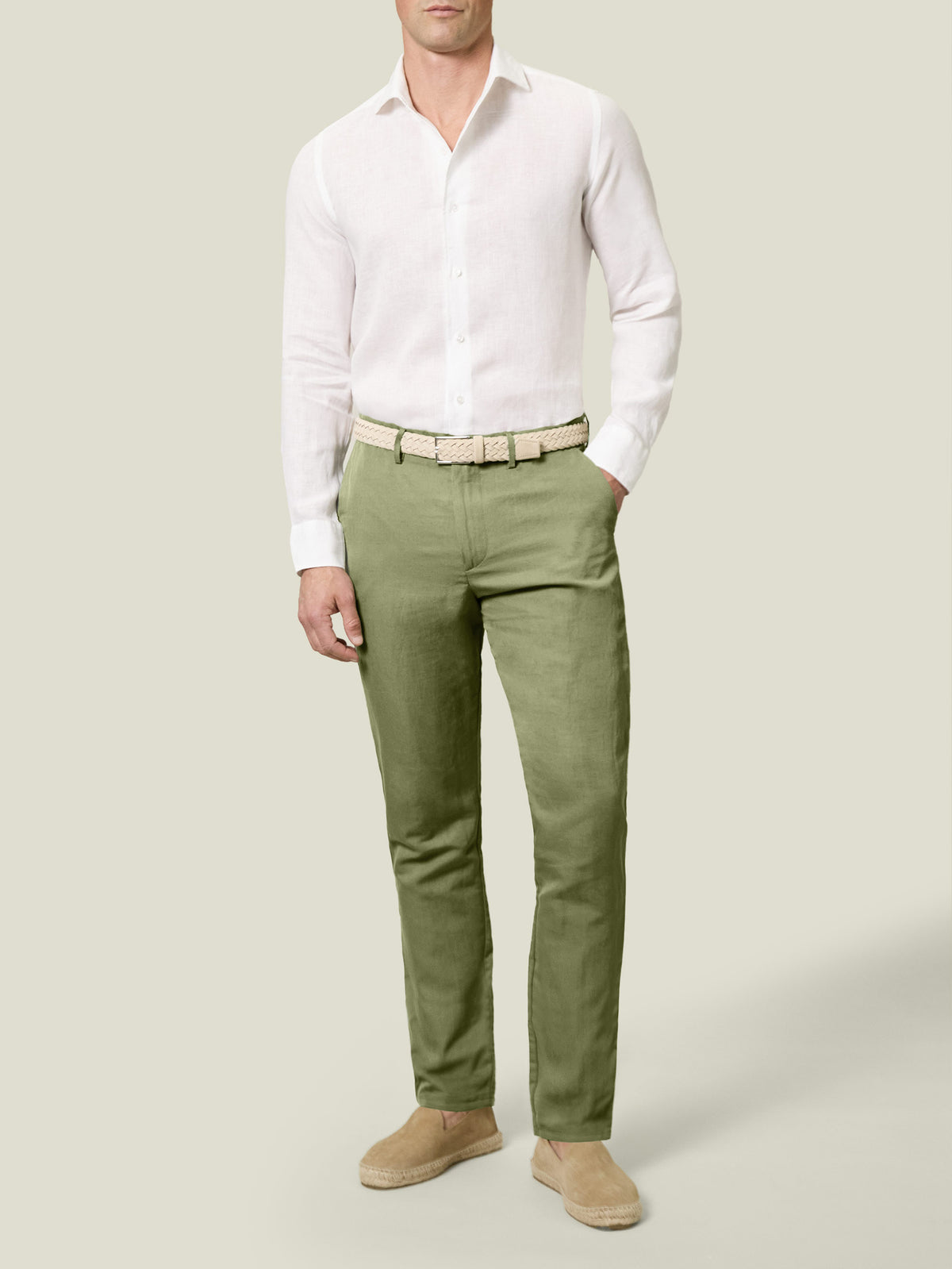 Front view of a model wearing Luca Faloni's Sage Green Linen Cotton Trousers with a white shirt and beige espadrilles.