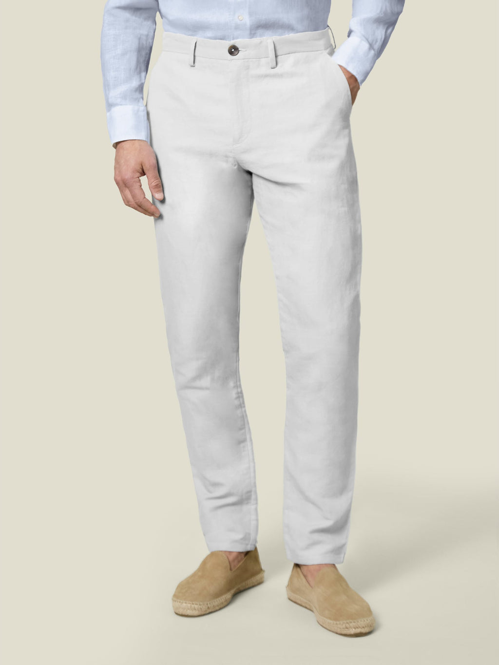 Front view of the Luca Faloni white Linen Cotton Trousers on a model, paired with a light blue shirt and tan espadrilles.