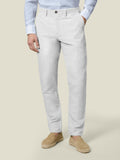 Front view of the Luca Faloni white Linen Cotton Trousers on a model, paired with a light blue shirt and tan espadrilles.