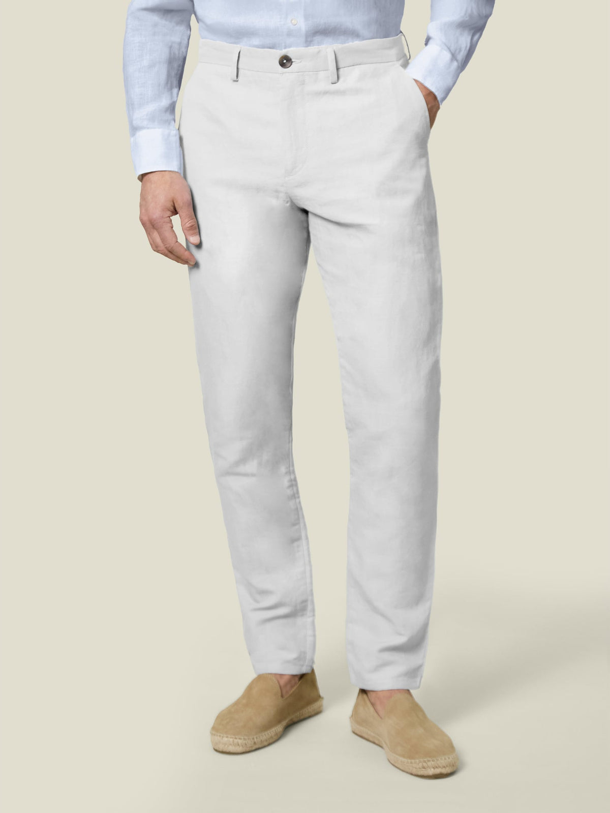 Front view of the Luca Faloni white Linen Cotton Trousers on a model, paired with a light blue shirt and tan espadrilles.