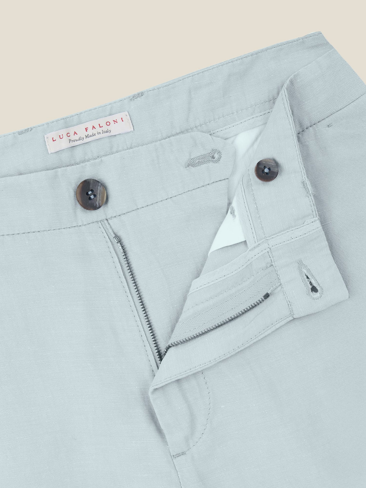 Close-up of the front of the Light Blue Linen Cotton Trousers, detailing the zip fly, horn buttons, and waistband.