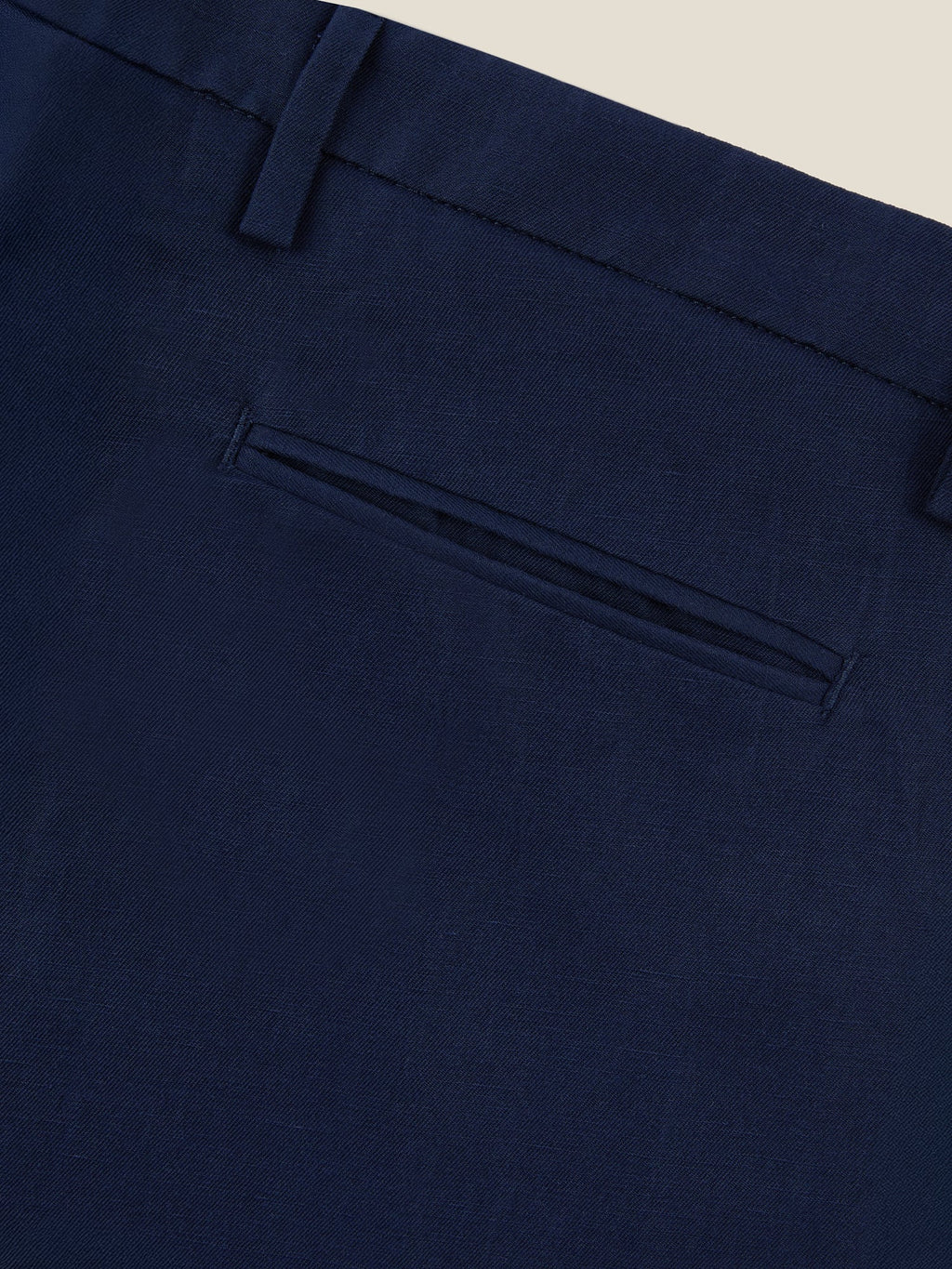 Close-up of the back welt pocket and belt loop on the Midnight Blue Linen Cotton Trousers, showing the fabric's texture.
