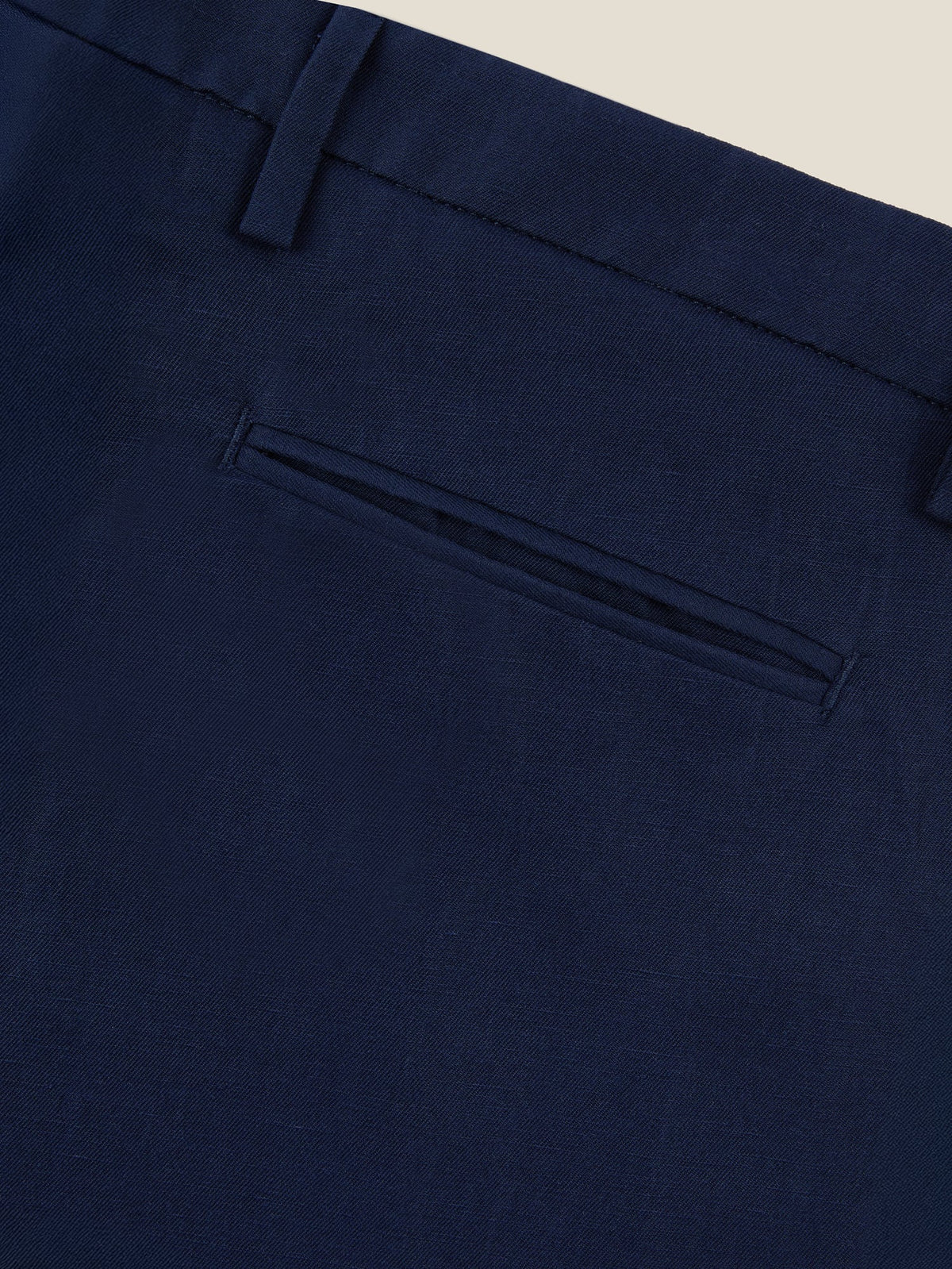 Close-up of the back welt pocket and belt loop on the Midnight Blue Linen Cotton Trousers, showing the fabric's texture.