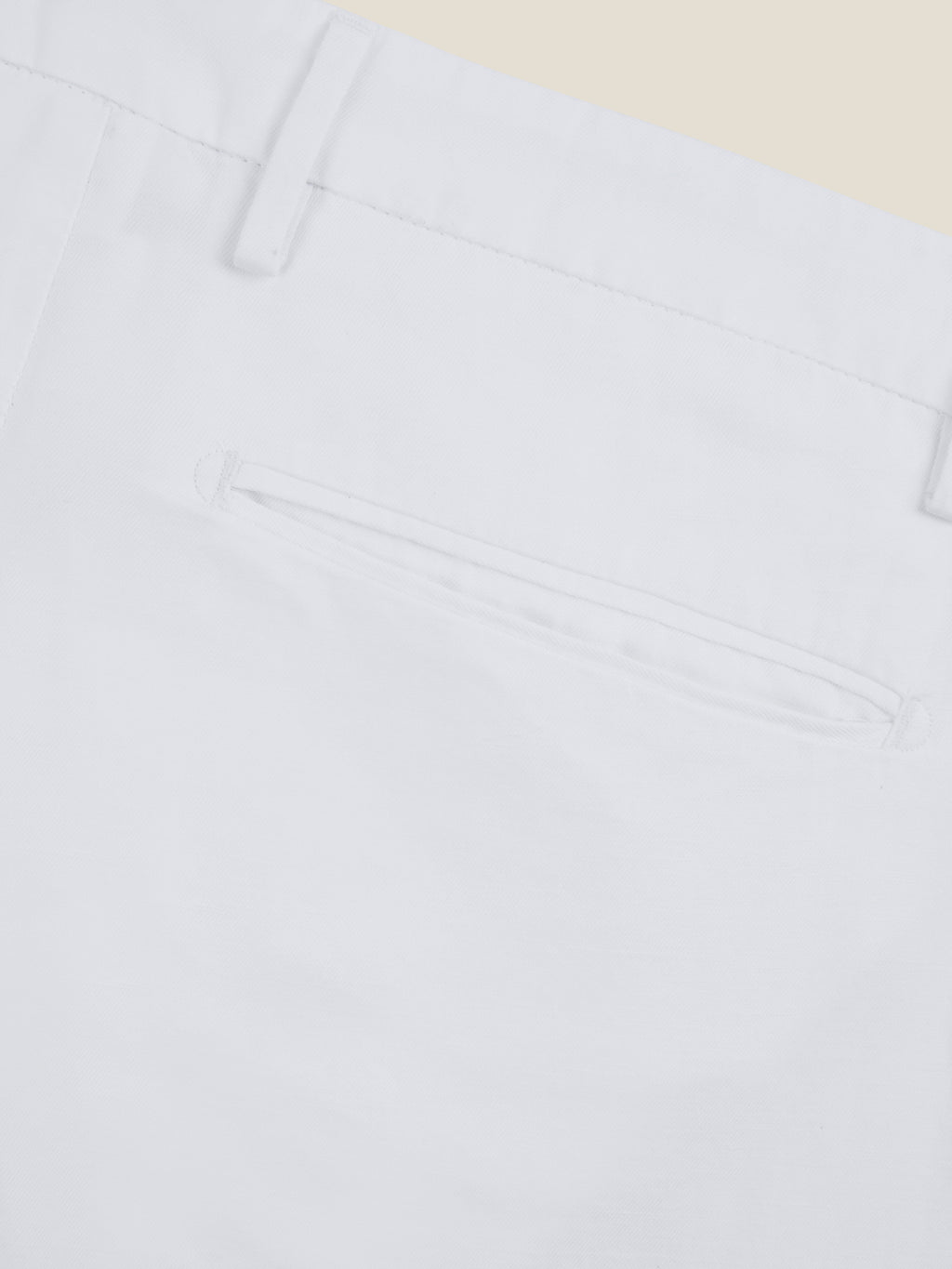 Close-up detail of the back welt pocket and belt loop of the white Linen Cotton Trousers.