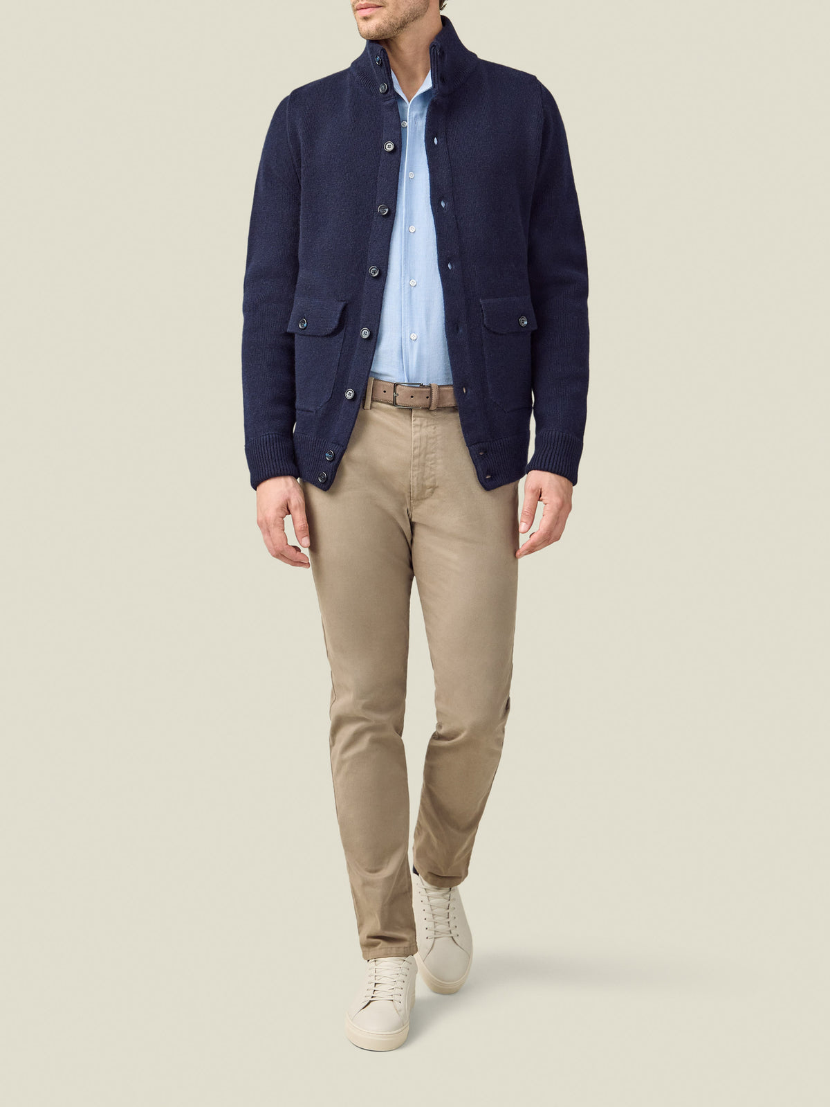 Front view of a model wearing Luca Faloni's Midnight Blue Cashmere Bomber, styled with a light blue shirt and beige chinos.