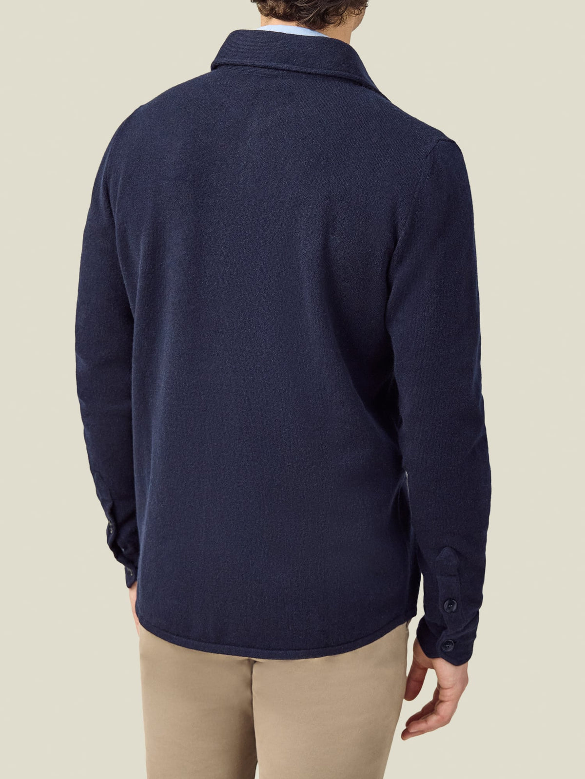 Back view of a model wearing the Luca Faloni Cashmere Overshirt in Midnight Blue, showcasing its relaxed fit and rounded hem.