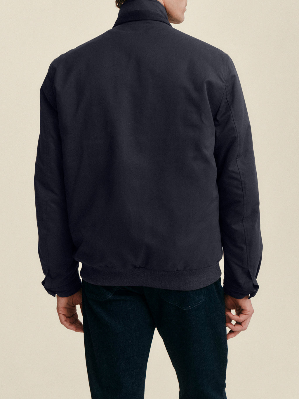 Back view of a model wearing the Luca Faloni City Jacket in midnight blue against a plain background.