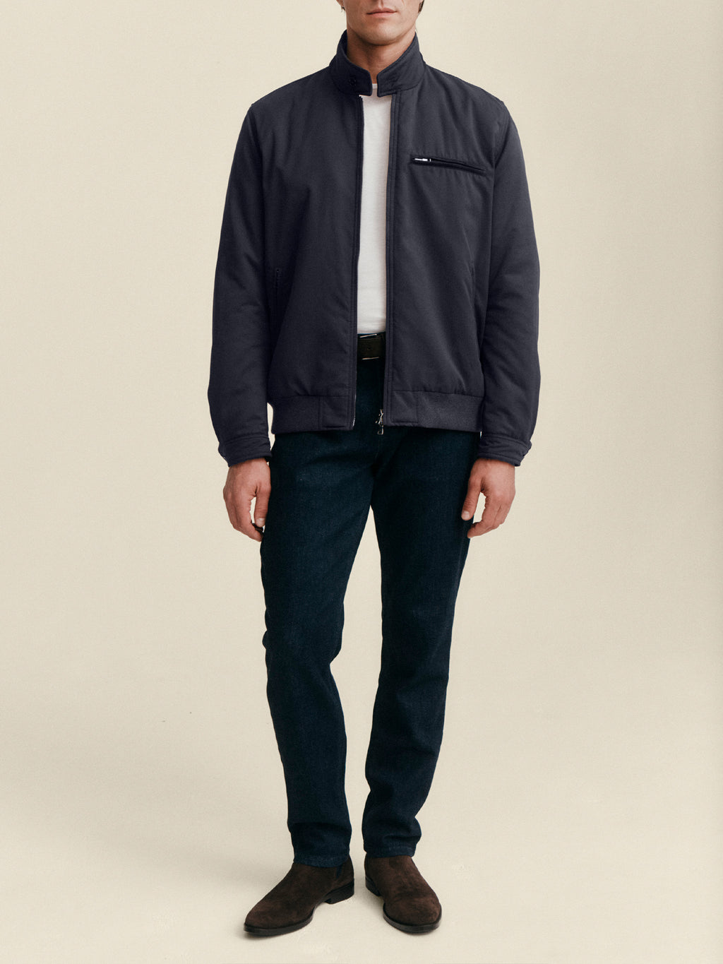 Front view of a model wearing the Luca Faloni City Jacket in midnight blue, styled with a white t-shirt and dark trousers.