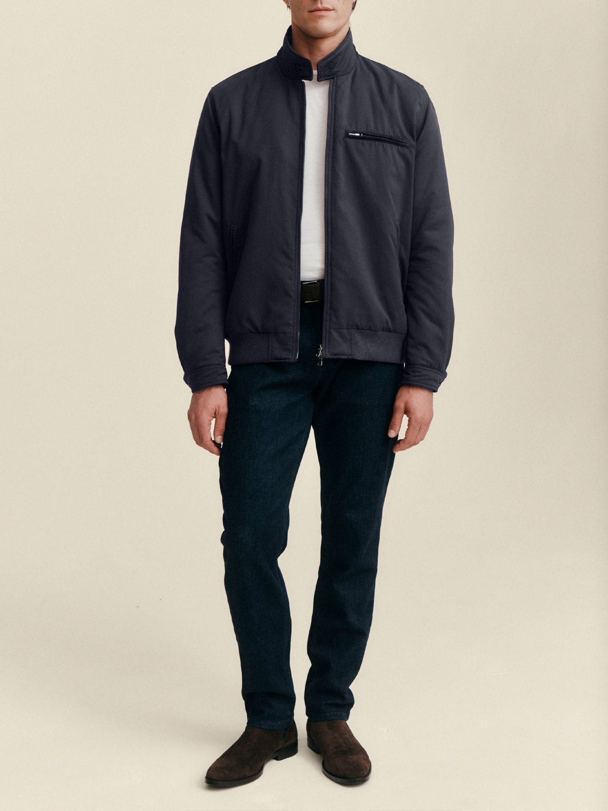 Front view of a model wearing the Luca Faloni City Jacket in midnight blue, styled with a white t-shirt and dark trousers.