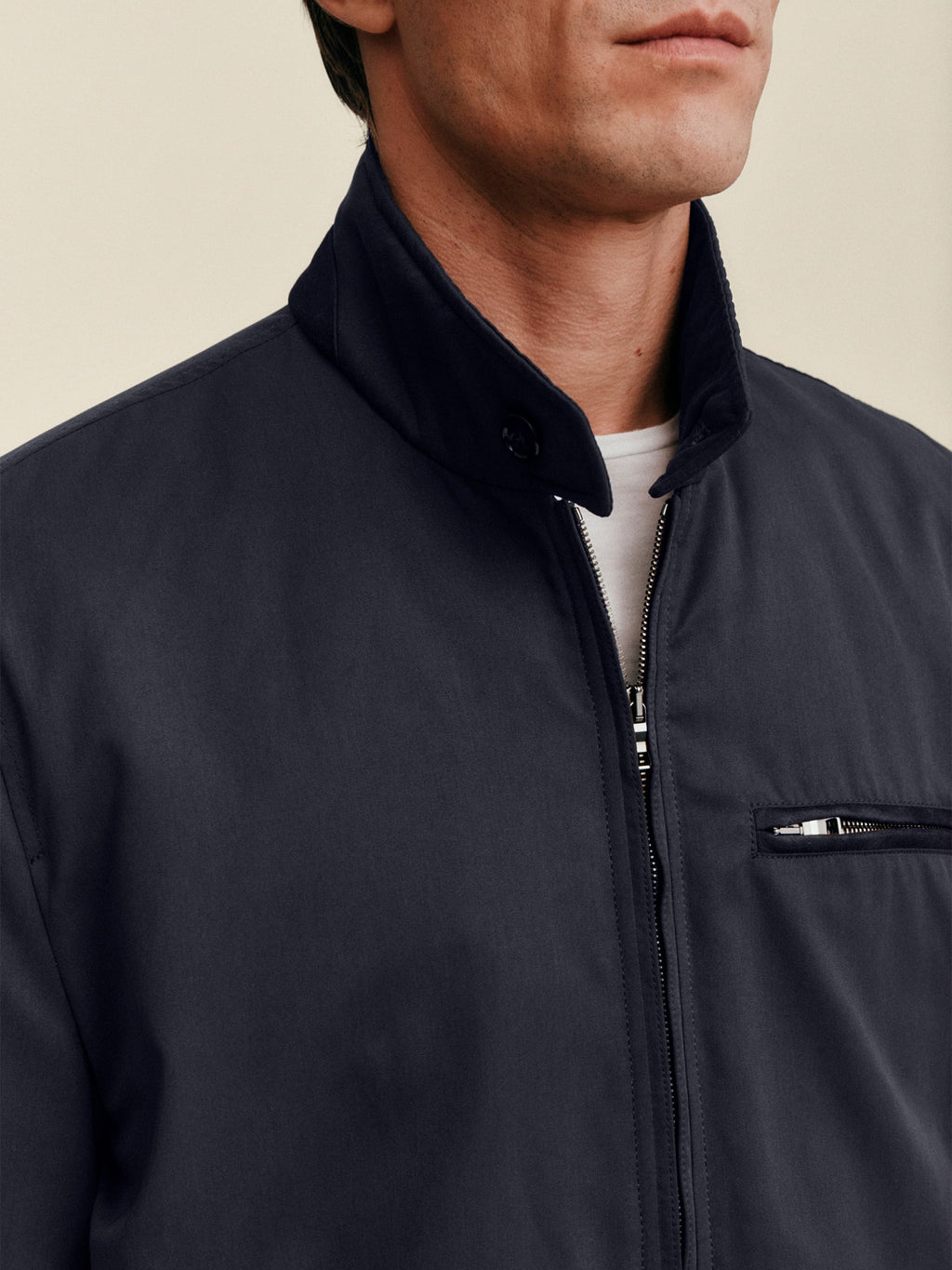 Close-up of a model wearing the Luca Faloni City Jacket in midnight blue, showing the suede collar and zip detail.
